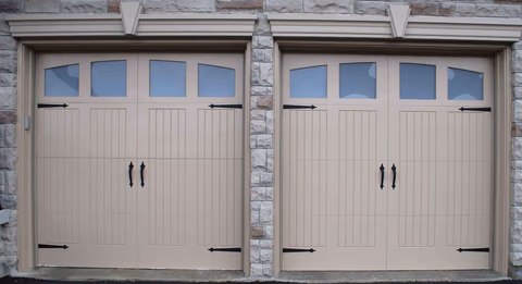 Professional garage door repair technician working on broken springs, cables, and rollers in Versailles, KY showing expert repair service