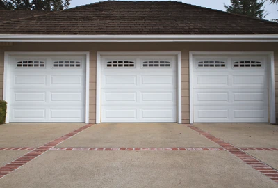 Professional garage door technician performing comprehensive tune-up maintenance service including lubrication, hardware inspection, balance testing, and safety system calibration to prevent breakdowns and extend garage door lifespan for Louisville homeowners