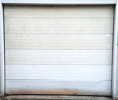 Professional garage door technician removing and replacing damaged garage door panel sections, showing expert panel replacement service to restore structural integrity, weather sealing, and enhanced curb appeal for Louisville residential properties