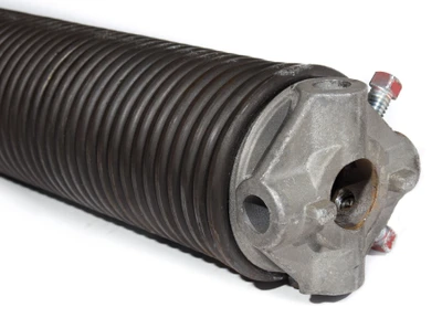 Professional garage door technician installing new high-tension torsion spring system above residential garage door showing expert spring replacement service with proper safety equipment and tools for Louisville homeowners